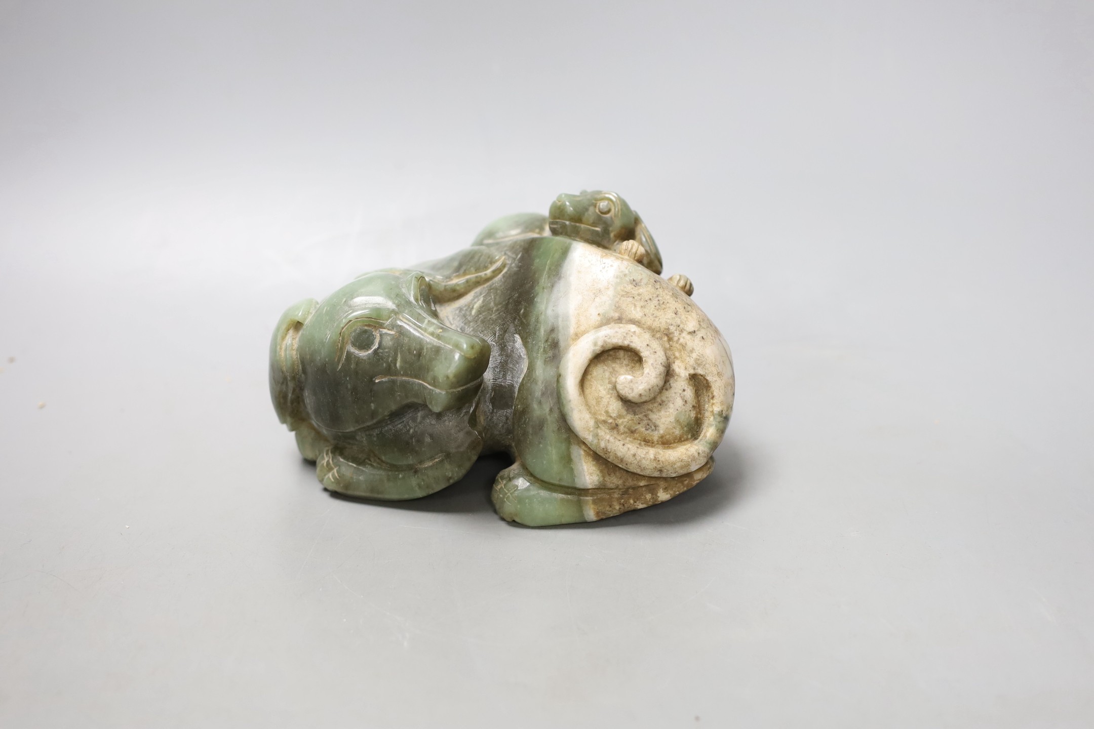 A Chinese spinach green and cream jade group of a dog and puppy, 15 cms